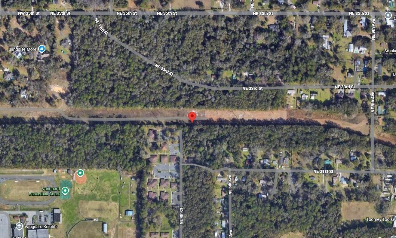 This is a satellite map view showing a wooded area with nearby streets and buildings — Tbd NE 4th Court, Ocala FL 34479, OCALA, FL