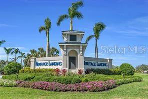 A stone monument sign for Heritage Landing stands surrounded by palm trees and landscaping — 14121 HERITAGE LANDING BOULEVARD UNIT 725, PUNTA GORDA, FL