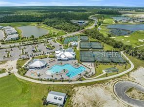 Aerial view of a community recreation center featuring a swimming pool and tennis courts — 14121 HERITAGE LANDING BOULEVARD UNIT 725, PUNTA GORDA, FL