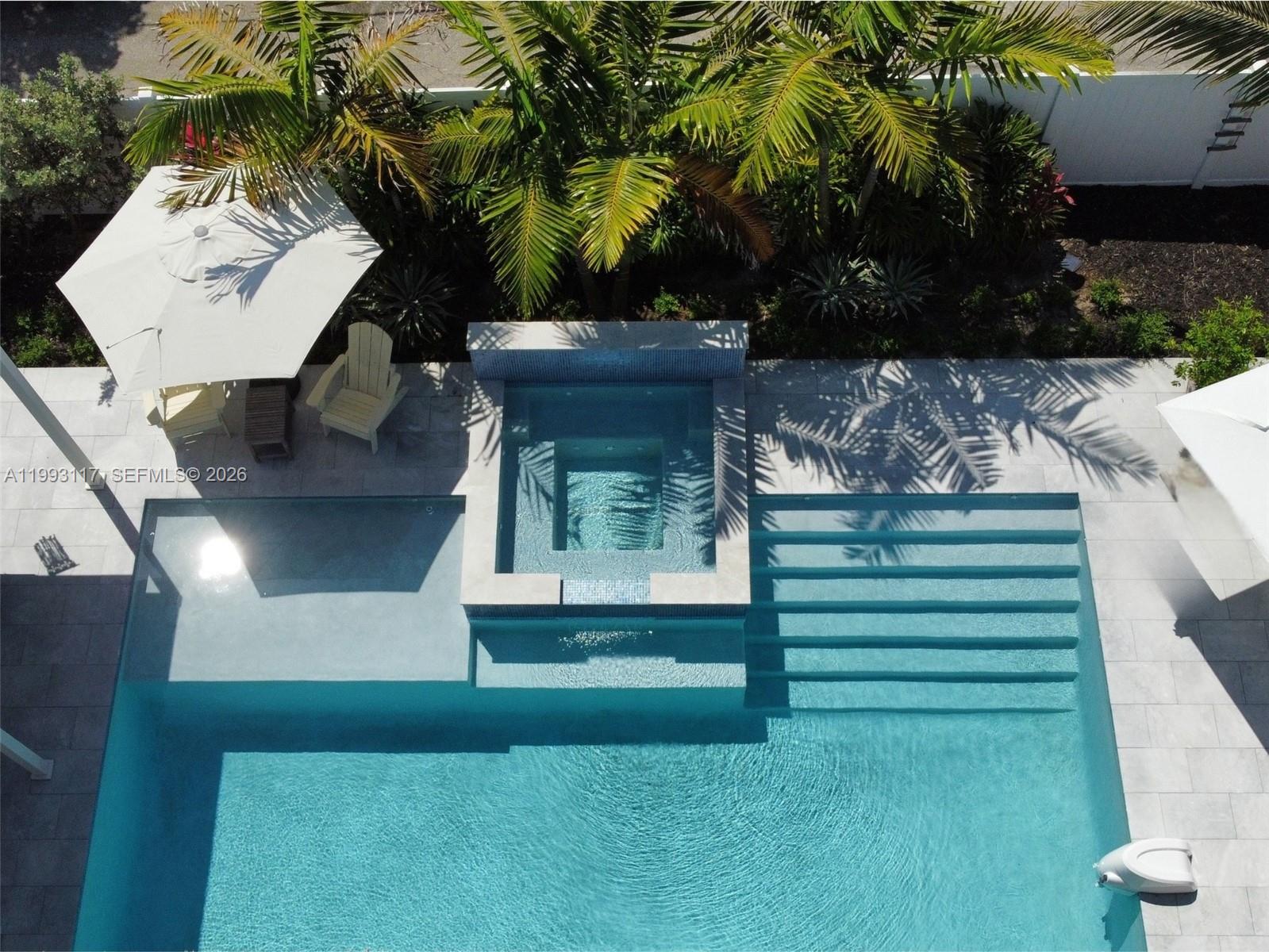 An aerial view shows a swimming pool with a spa, tanning ledge, and stairs — 426 SE 3rd St, Dania Beach FL 33004, DANIA BEACH, FL
