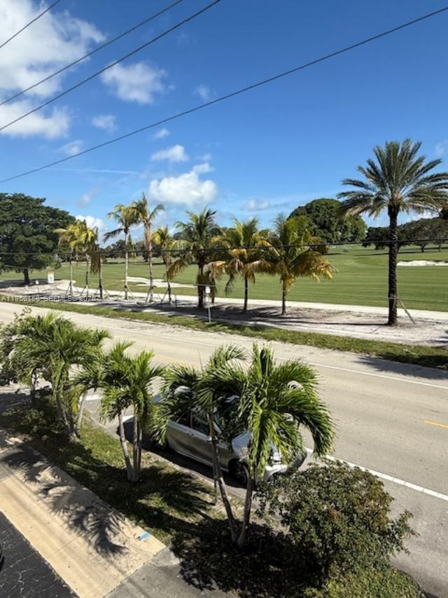 An elevated view of a road lined with palm trees bordering a golf course — 1700 Pierce St # 204, Hollywood FL 33020, HOLLYWOOD, FL