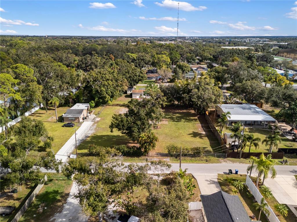 A vacant, grassy lot is enclosed by a chain-link fence with a palm tree nearby — 0 HOULE AVENUE, SARASOTA, FL