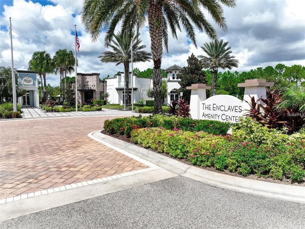 A paved entrance leads to a community amenity center with palm trees and landscaping — 840 BENOI DR DRIVE, DAVENPORT, FL