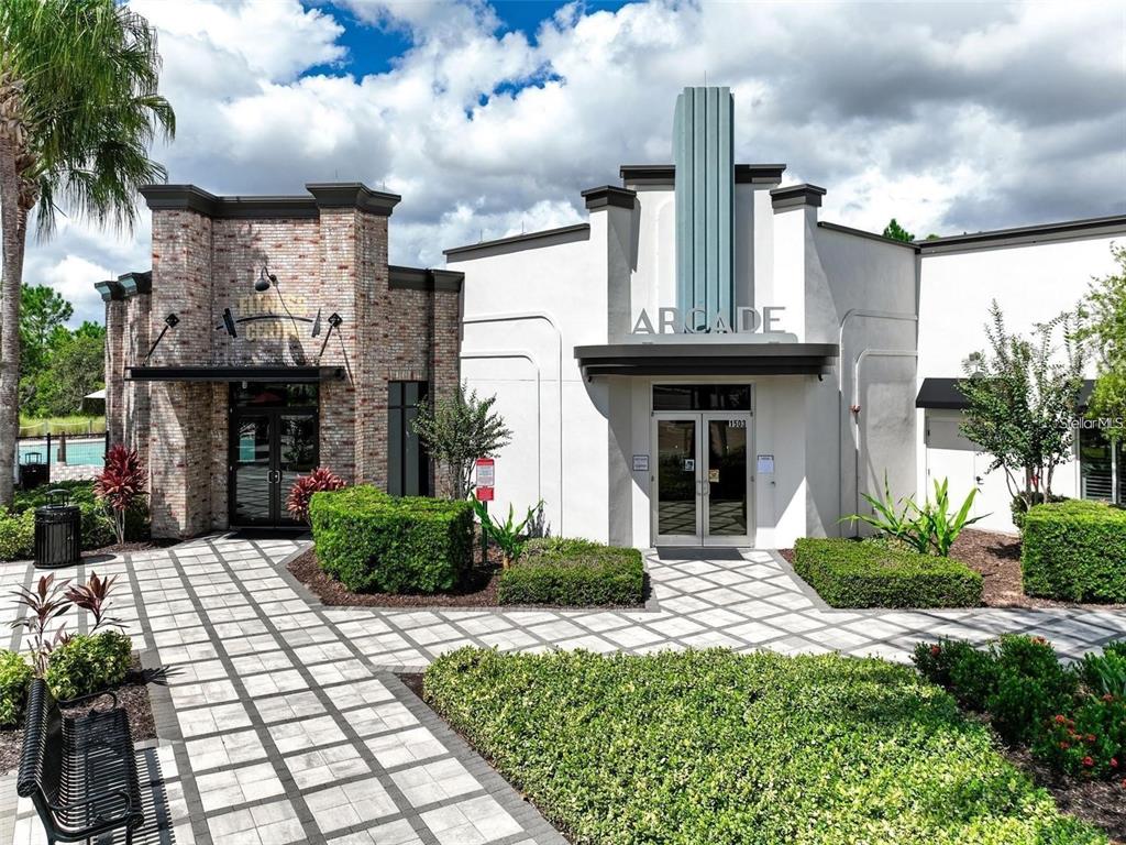 The exterior of a building features a brick fitness center and an adjacent arcade entrance — 840 BENOI DR DRIVE, DAVENPORT, FL