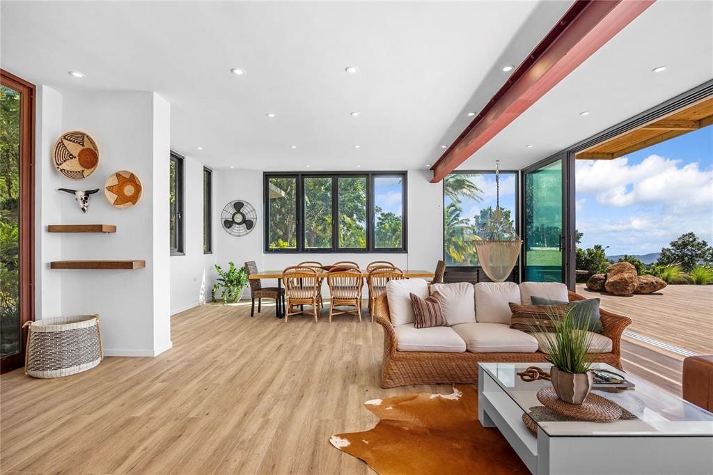 A bright, open-concept living and dining area features light wood floors and a large deck — 24-2 Bo. Pena Pobre KM 2.3 VISTA DEL ESTE, NAGUABO, PR