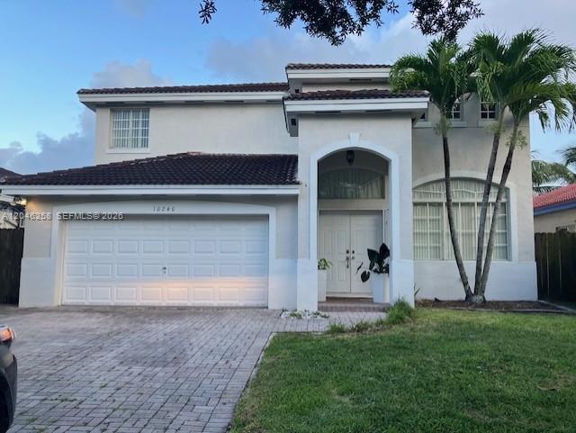 A two-story house with a white stucco facade, tiled roof, and a paved driveway — 10240 SW 227th Ln, Cutler Bay FL 33190, CUTLER BAY, FL