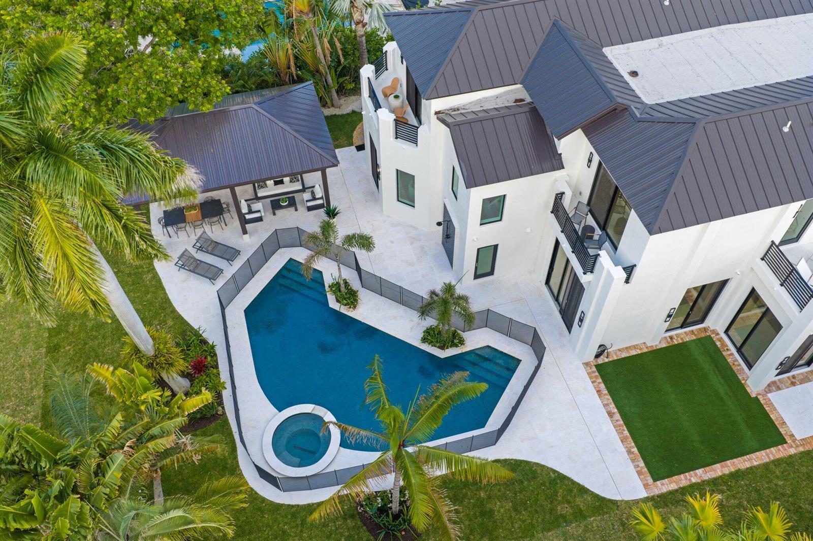 An aerial view shows a white house with a dark roof, pool, and patio area — 23 Coconut Lane, Ocean Ridge FL 33435, OCEAN RIDGE, FL