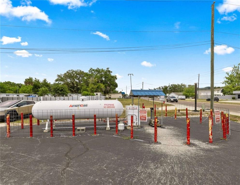 An outdoor propane storage tank and filling station are enclosed by a wire fence — 2926/3010 NE JACKSONVILLE ROAD, OCALA, FL