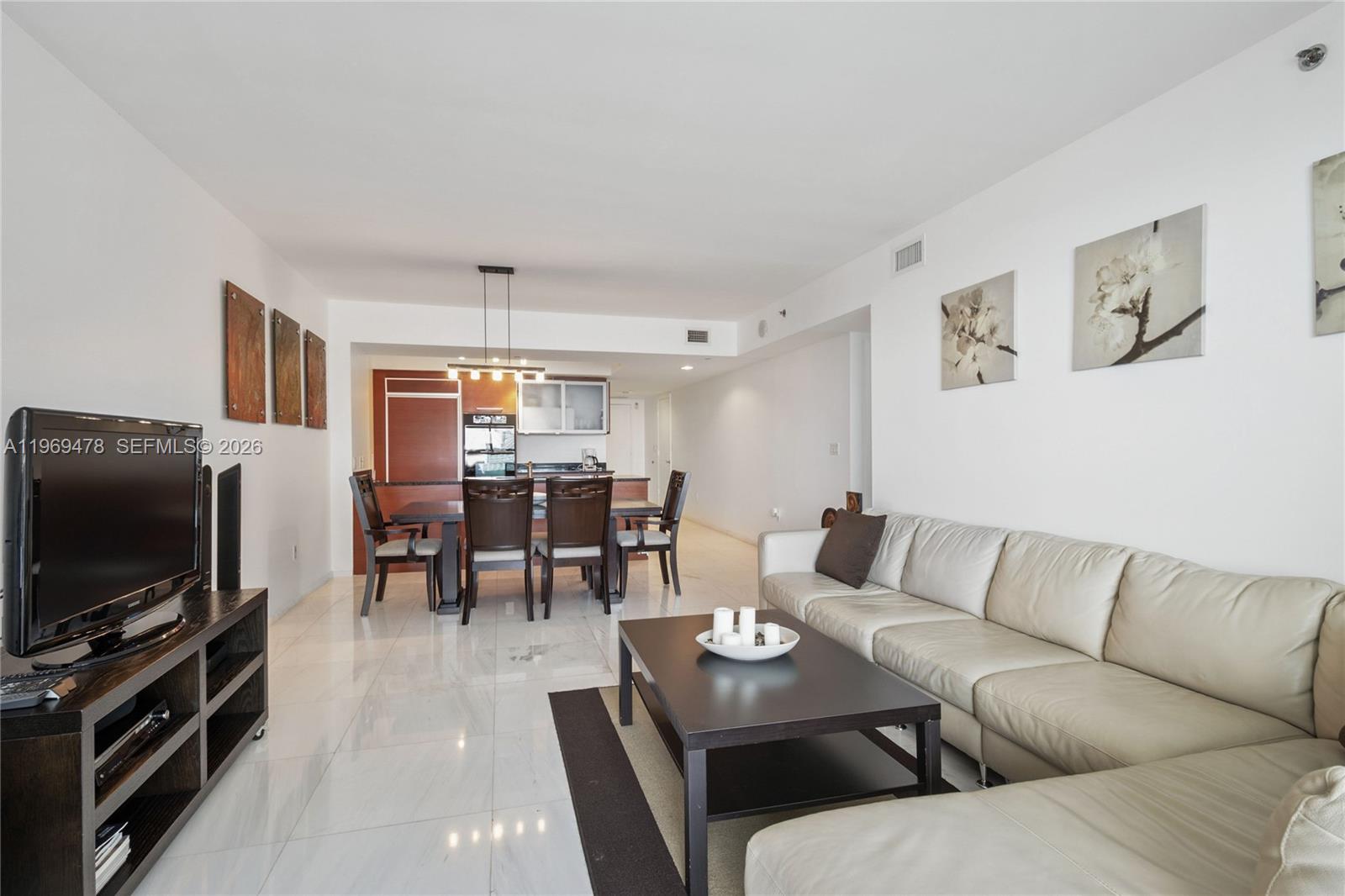 A living room and dining area feature white tile floors, a leather sofa, and kitchen — 1830 S OCEAN DR # 3211, Hallandale Beach FL 33009, HALLANDALE BEACH, FL