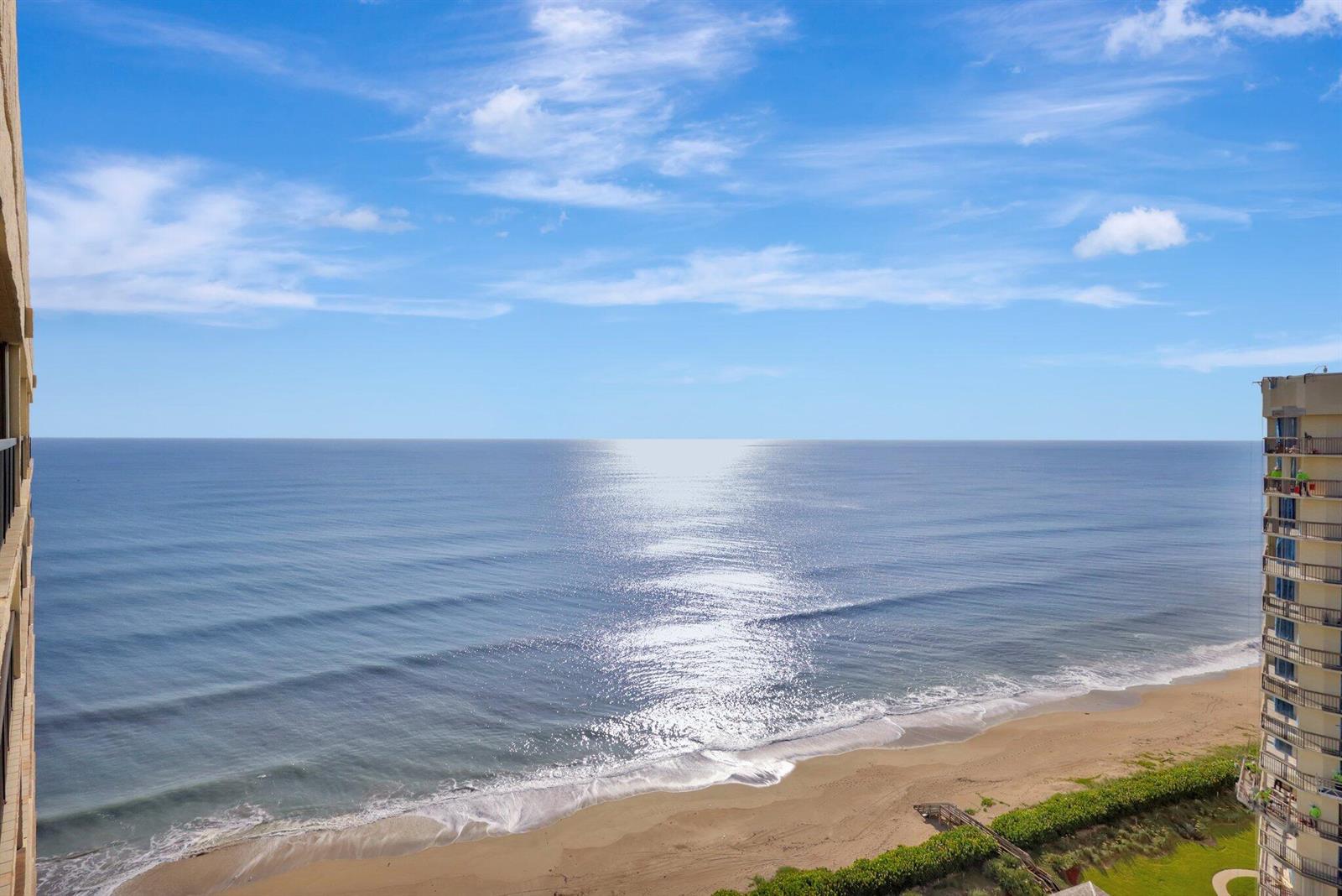 An elevated view of a sandy beach and ocean between two high-rise buildings — 9500 S Ocean Drive # 10, Jensen Beach FL 34957, JENSEN BEACH, FL