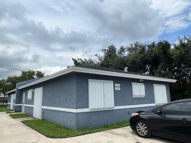 A single-story blue house with white trim and hurricane shutters on the windows — 2249 NW 66th St # 2249, Miami FL 33147, MIAMI, FL