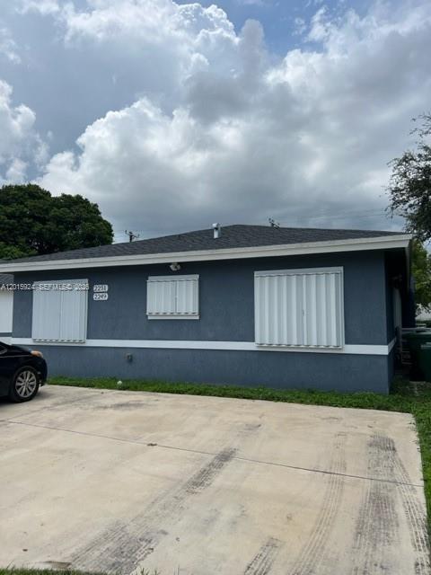A single-story gray house with white hurricane shutters and a concrete driveway — 2249 NW 66th St # 2249, Miami FL 33147, MIAMI, FL
