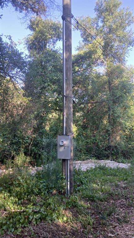An electrical meter and conduit are mounted on a wooden utility pole outdoors — 0 AND TBD, WEBSTER, FL