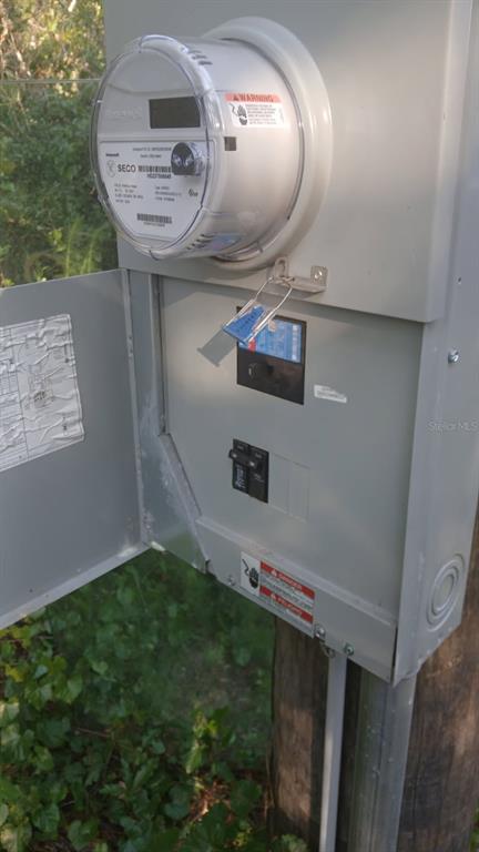 An outdoor electrical meter and breaker box are mounted on a wooden utility pole — 0 AND TBD, WEBSTER, FL