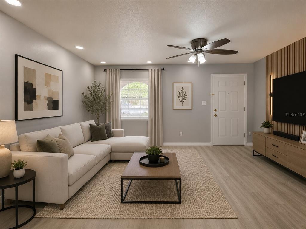 A living room features a sectional sofa, a coffee table, and a wall-mounted television — 775 HILLVIEW DRIVE, ALTAMONTE SPRINGS, FL