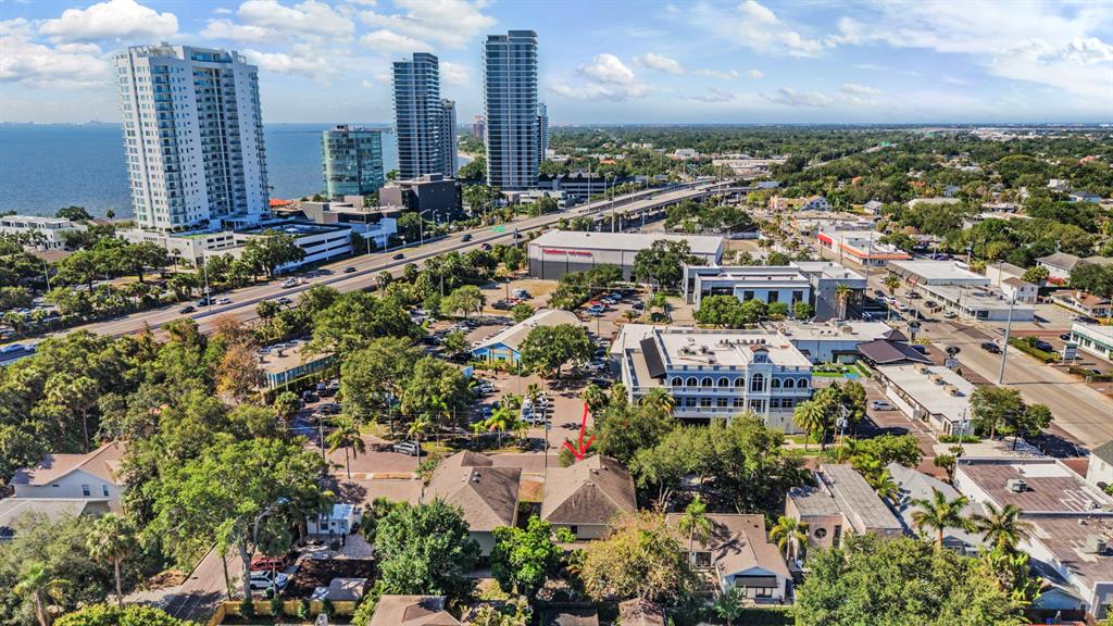 An aerial view shows a residential house with a red arrow pointing to its roof — 3007 W PALMIRA AVENUE, TAMPA, FL