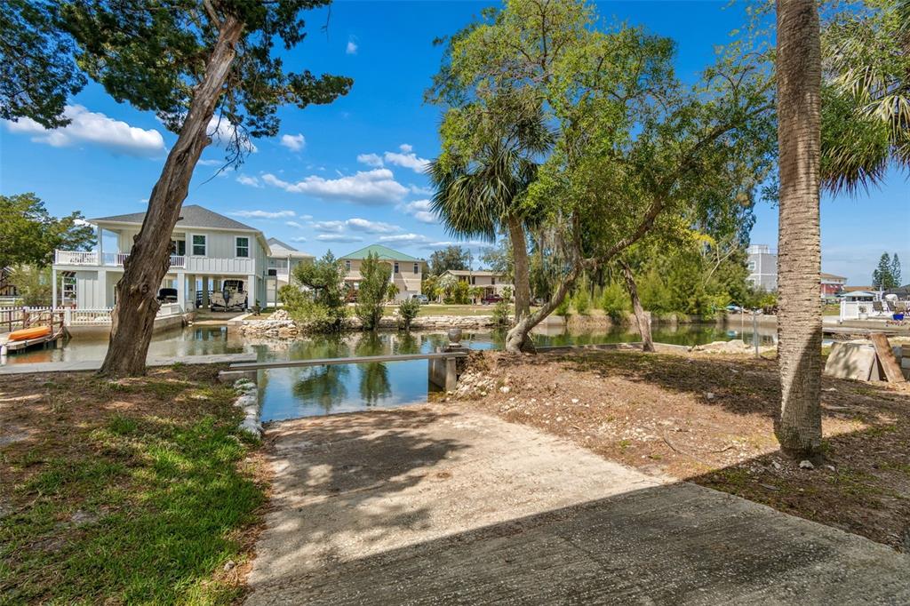 A sunroom with a wood-plank ceiling, stone-patterned floor, and a table with four bar stools — 14539 COFFEY LANE, HUDSON, FL