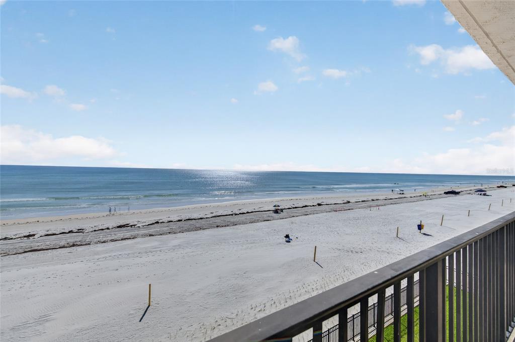 A view of a sandy beach and the ocean from a balcony — 3001 S ATLANTIC AVENUE UNIT 433, NEW SMYRNA BEACH, FL