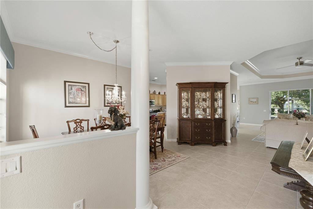 A dining area and living room are visible in this open-concept home with tile flooring — 8821 SW 82ND COURT ROAD, OCALA, FL