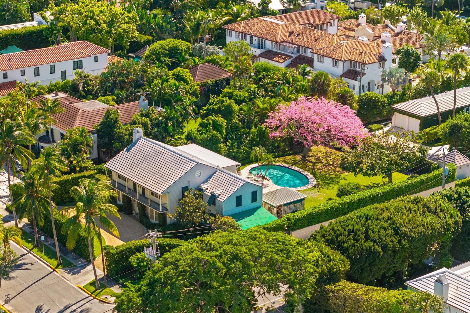 An aerial view of a house with a pool and a large blooming pink tree — 334 Barton Avenue, Palm Beach FL 33480, PALM BEACH, FL