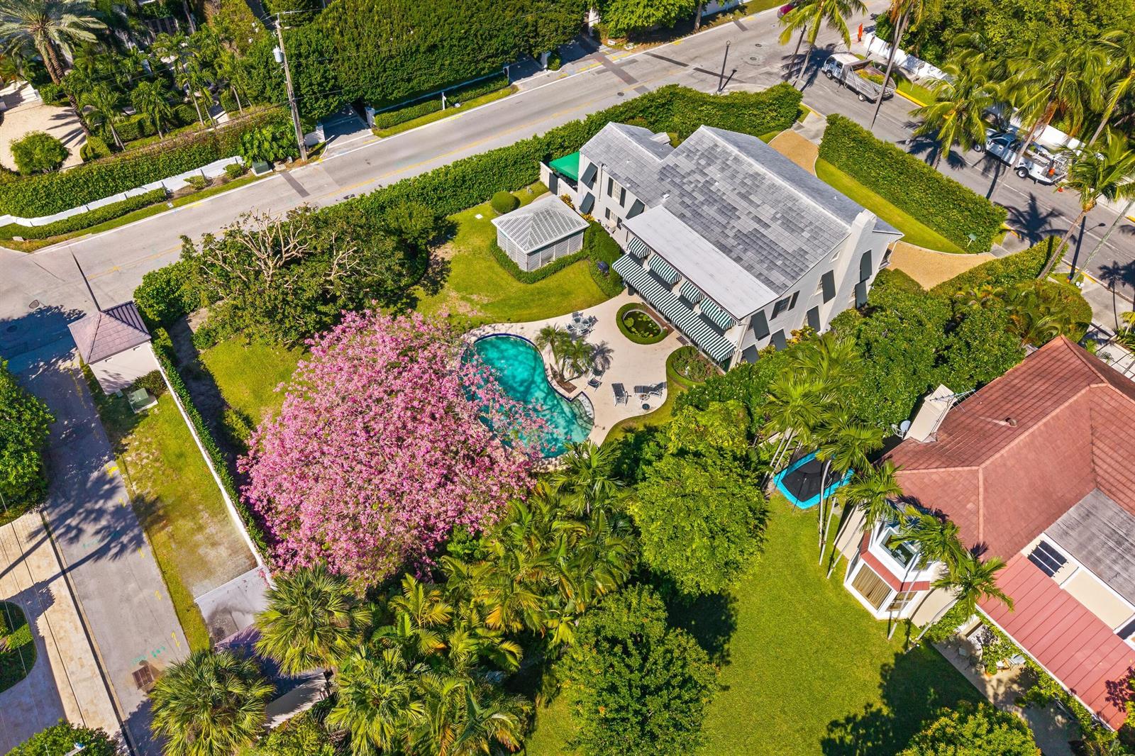 An aerial view shows a two-story house with a swimming pool and a large flowering tree — 334 Barton Avenue, Palm Beach FL 33480, PALM BEACH, FL