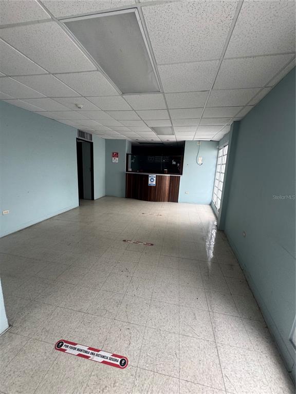 An empty office space features light blue walls, a drop ceiling, and a reception counter — Pavia Medical Plaza AMÉRICO SALAS, SAN JUAN, PR