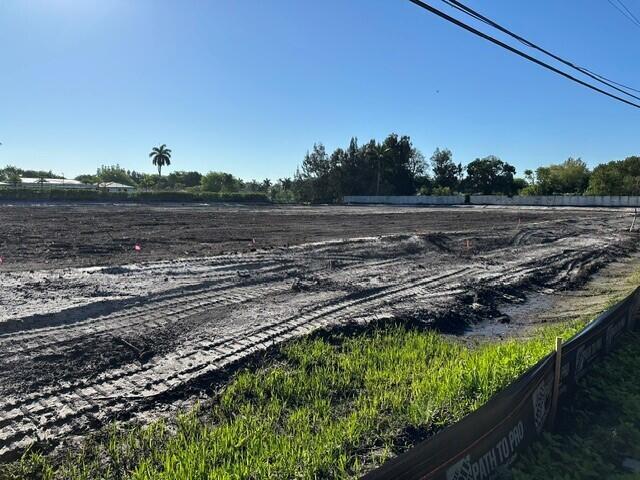 A large, cleared, muddy construction site with tire tracks under a clear blue sky — 4800 SW 78th Avenue, Davie FL 33328, DAVIE, FL