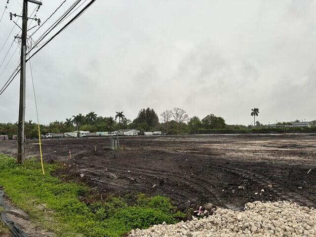 A large, cleared, muddy lot features a utility pole and distant trees under a sky — 4800 SW 78th Avenue, Davie FL 33328, DAVIE, FL