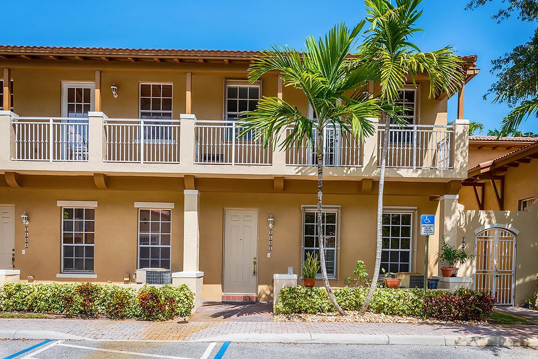 A two-story tan building with a balcony, palm trees, and a paved parking area — 2502 NW 4th Street, Boynton Beach FL 33426, BOYNTON BEACH, FL