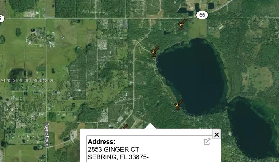 This is a satellite map showing a residential area near a lake with auction icons — 2853 Ginger Ct, Sebring FL 33875, SEBRING, FL