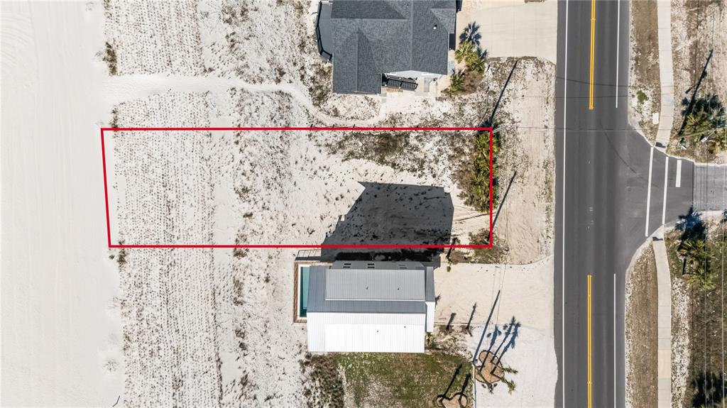 An aerial view shows a rectangular vacant beachfront lot outlined in red next to a house — 1817 HIGHWAY 98, MEXICO BEACH, FL
