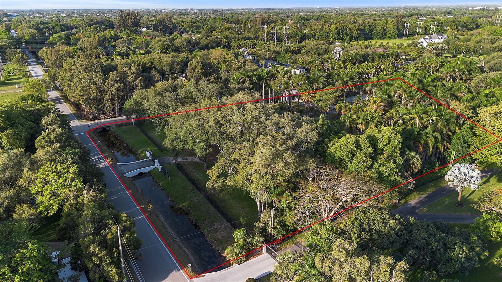 An aerial view shows a wooded residential lot outlined in red next to a road — 6541 Melaleuca Rd, Southwest Ranches FL 33330, SOUTHWEST RANCHES, FL