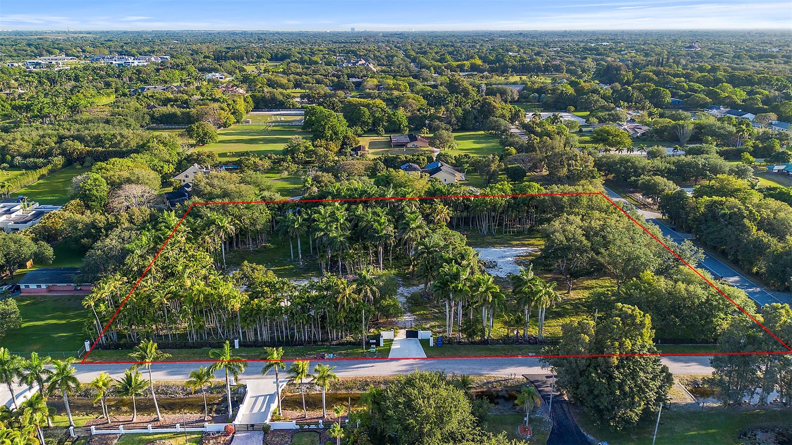 An aerial view shows a rectangular, tree-filled lot outlined in red along a paved road — 6541 Melaleuca Rd, Southwest Ranches FL 33330, SOUTHWEST RANCHES, FL