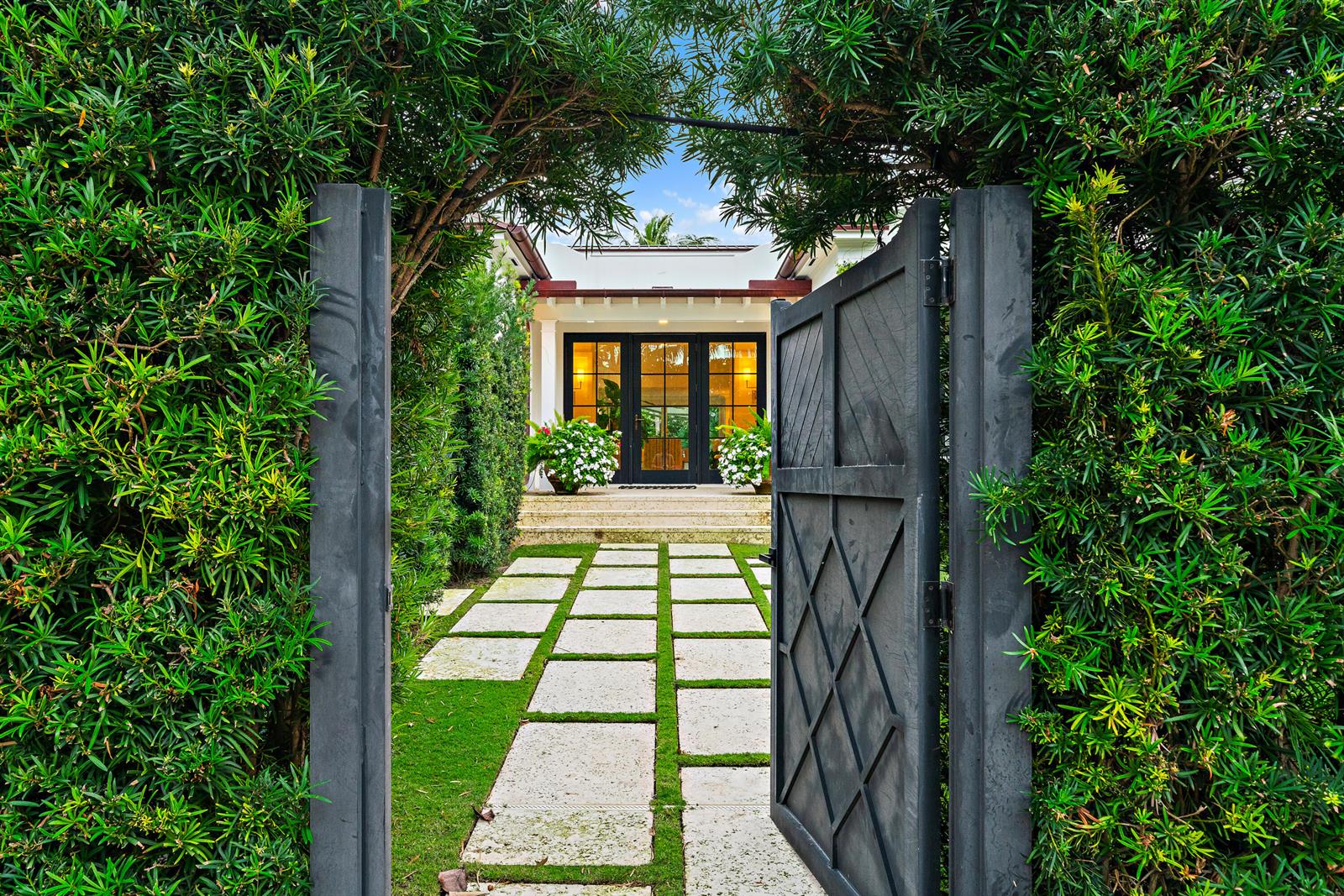 A stone path leads through an open gate toward a house with glass doors — 160 Chilean Avenue, Palm Beach FL 33480, PALM BEACH, FL