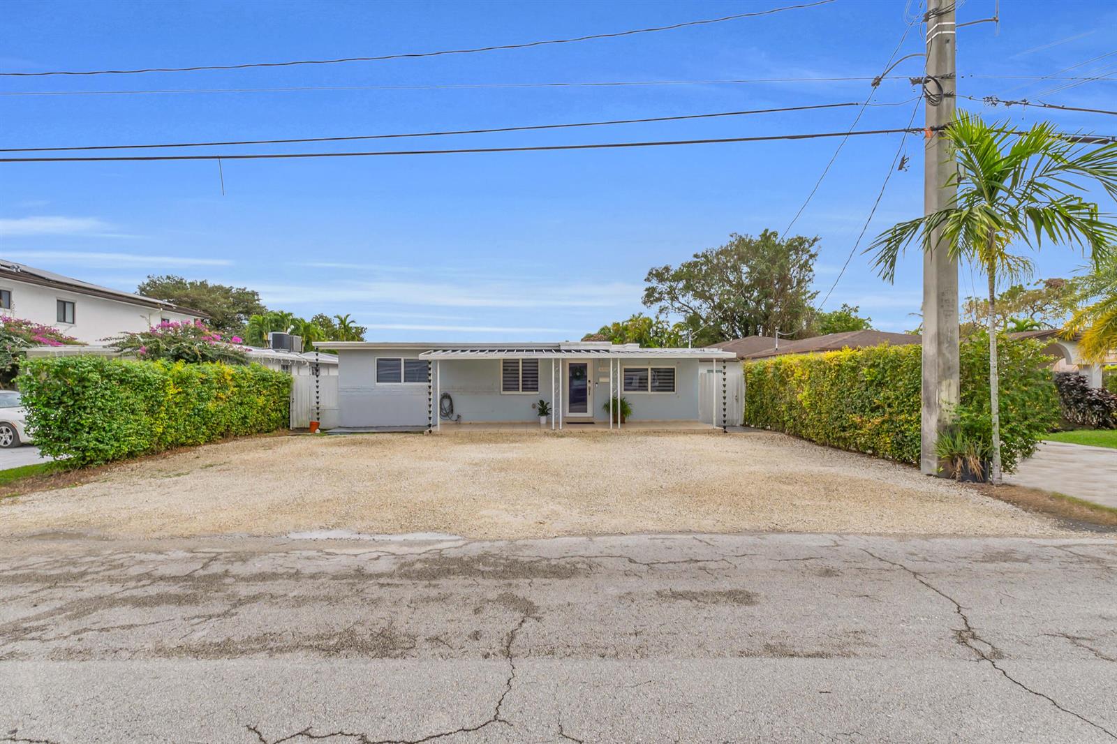 A single-story house with a gravel driveway and a covered front porch sits behind hedges — 6350 SW 32 Street, Miami FL 33155, MIAMI, FL