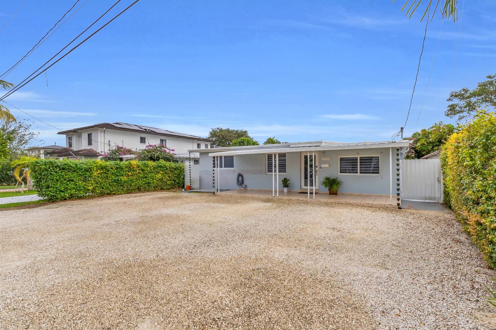 A single-story house with a gravel driveway and a covered front porch — 6350 SW 32 Street, Miami FL 33155, MIAMI, FL