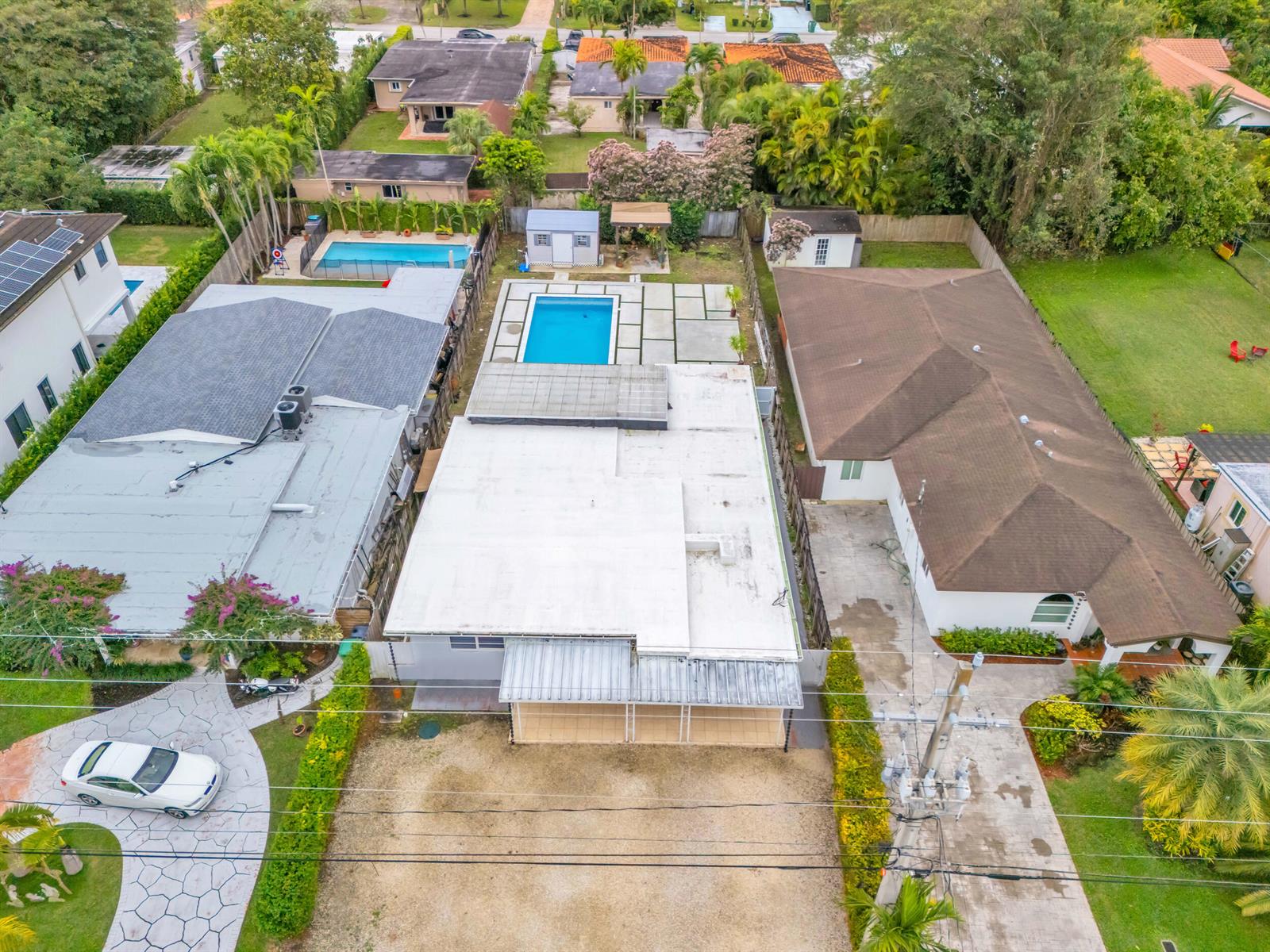 An aerial view shows three residential properties with swimming pools and paved driveways — 6350 SW 32 Street, Miami FL 33155, MIAMI, FL