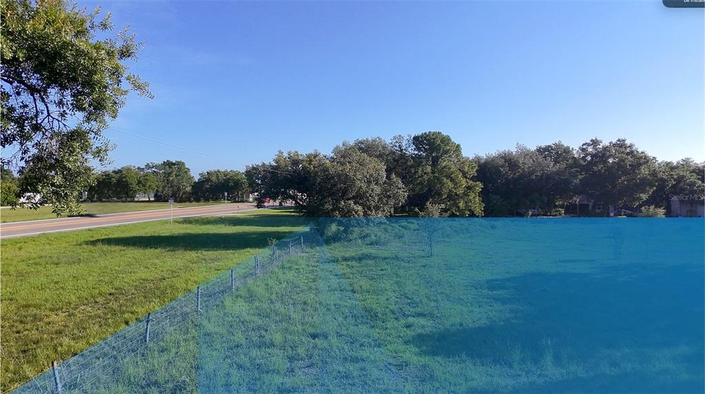 An outdoor view of a grassy lot with a wire fence and a nearby road — N Sr 29 N SR 29, LABELLE, FL