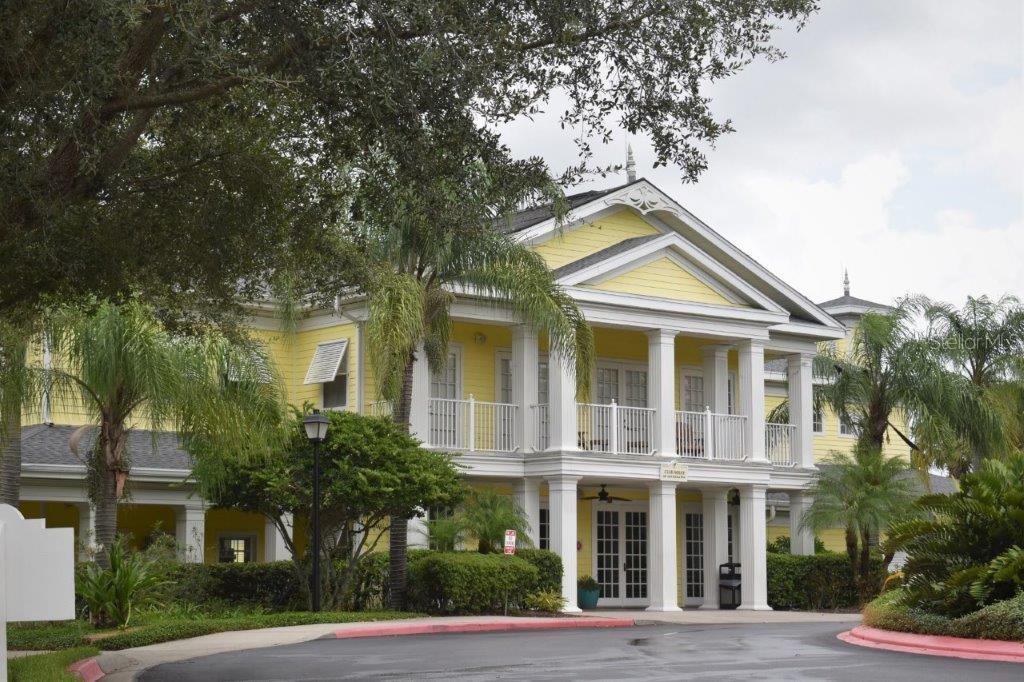 A two-story yellow building with a white columned porch and a triangular roof gable — 802 GRAN BAHAMA BOULEVARD UNIT 802, DAVENPORT, FL