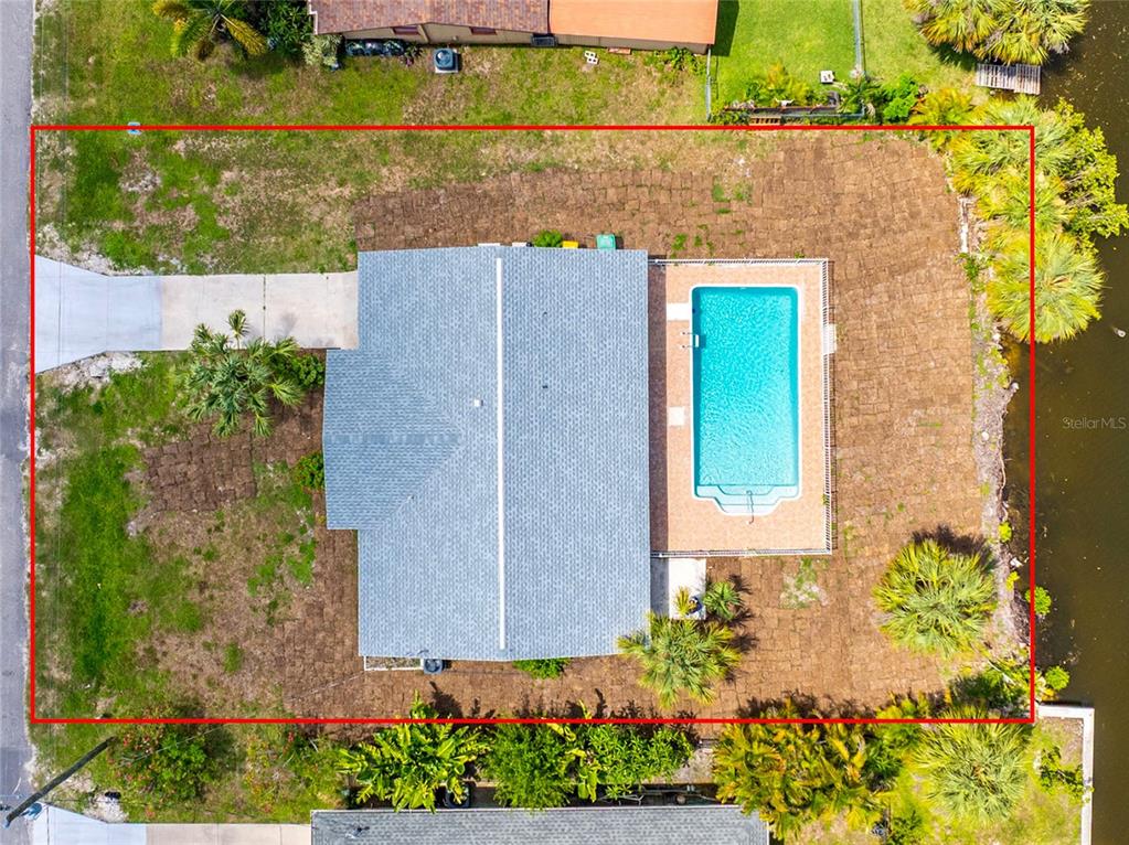 An aerial view of a house with a swimming pool and a large backyard — 18321 WOLBRETTE CIRCLE, PORT CHARLOTTE, FL