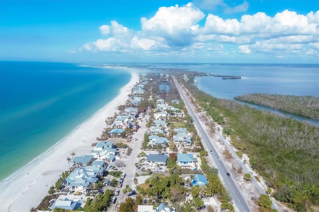 Aerial view of a coastal road lined with houses between the ocean and a bay — 2420 24TH STREET W, BOCA GRANDE, FL