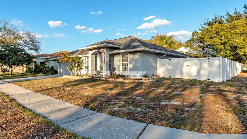 A single-story house with a gray exterior, a white fence, and a front yard — 5410 LINDBURG STREET, RIVERVIEW, FL