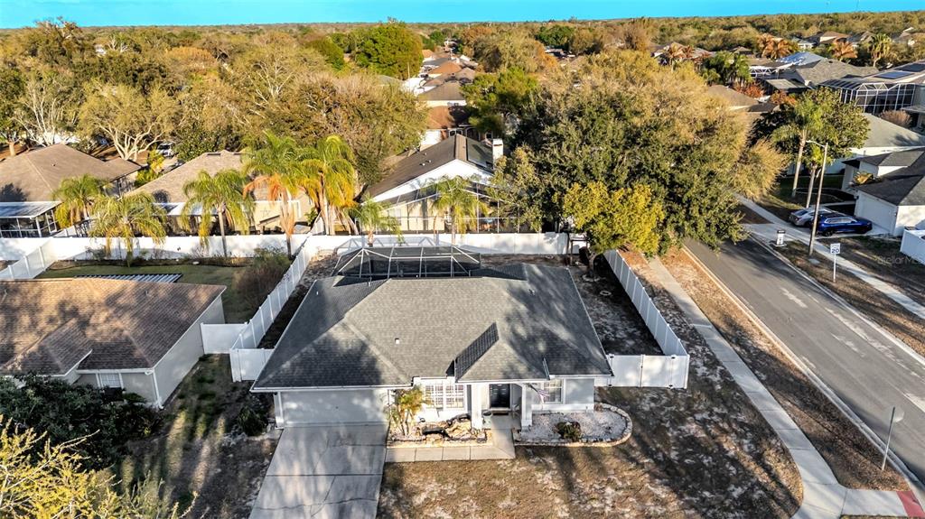 An aerial view shows a single-story house with a gray roof and a fenced yard — 5410 LINDBURG STREET, RIVERVIEW, FL