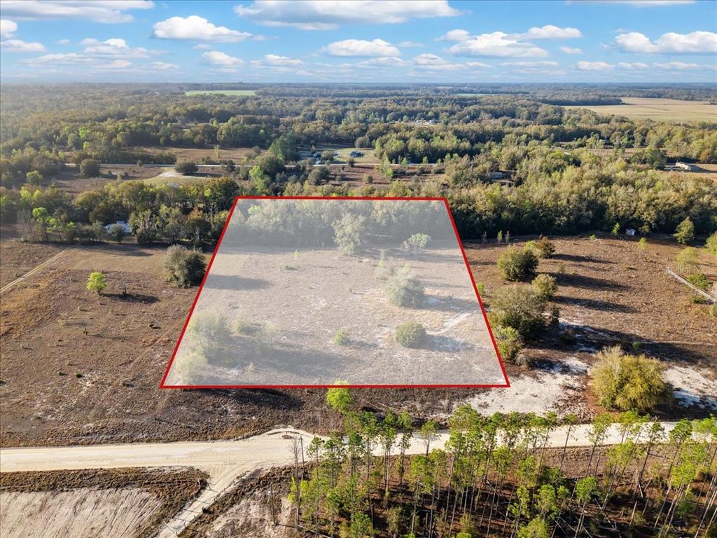 An aerial view shows a rectangular plot of land outlined in red near a road — TBD 000 NW 98TH LANE, BRANFORD, FL