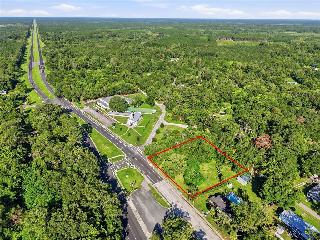 An aerial view shows a rectangular plot of land outlined in red near a road — 00 SW 4TH BOULEVARD, WALDO, FL