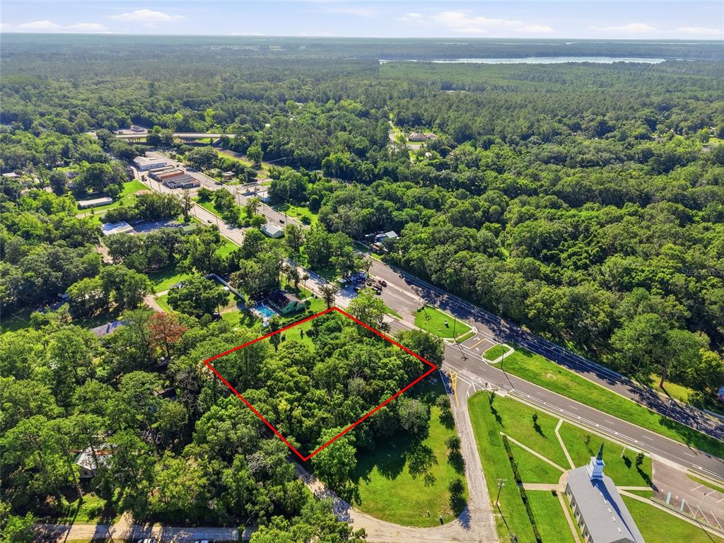 An aerial view shows a wooded, rectangular plot of land outlined in red near a road — 00 SW 4TH BOULEVARD, WALDO, FL