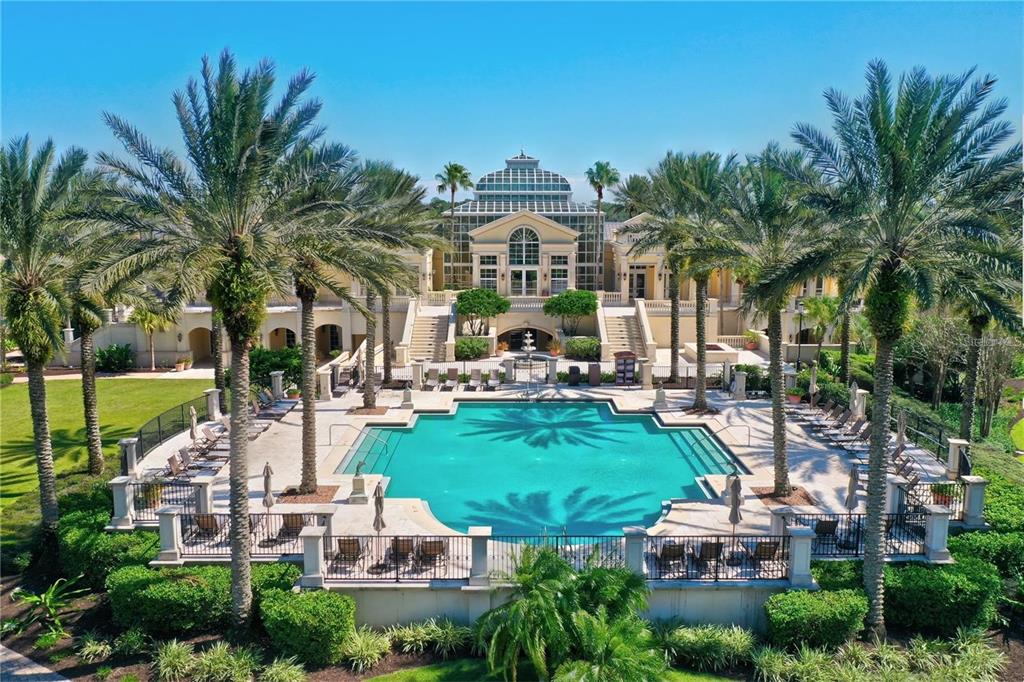 An aerial view of a large swimming pool in front of a multi-story building — 491 SWEETGUM LANE, PALM COAST, FL
