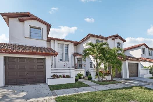 A row of white two-story townhouses with brown tile roofs and attached garages — 20930 SW 83rd Ave, Cutler Bay FL 33189, CUTLER BAY, FL