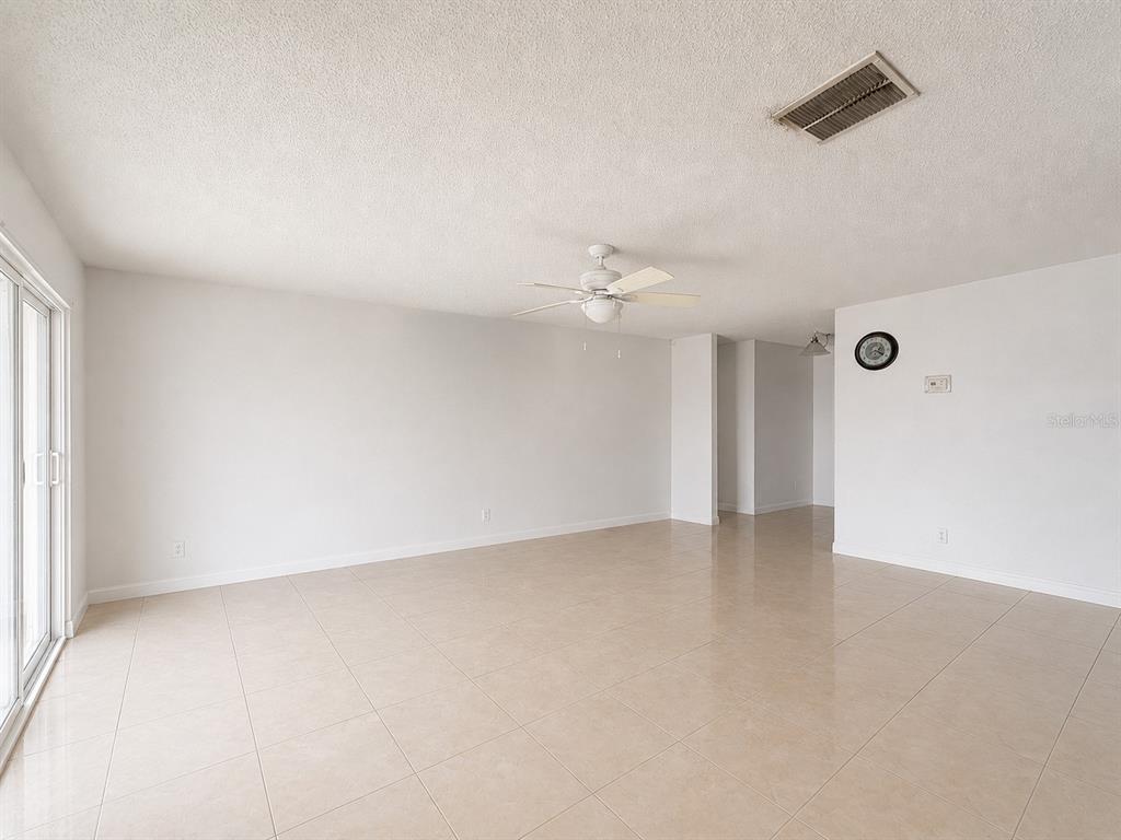An empty room with white walls, tile flooring, and a ceiling fan — 5406 ARPANA DRIVE, ORLANDO, FL