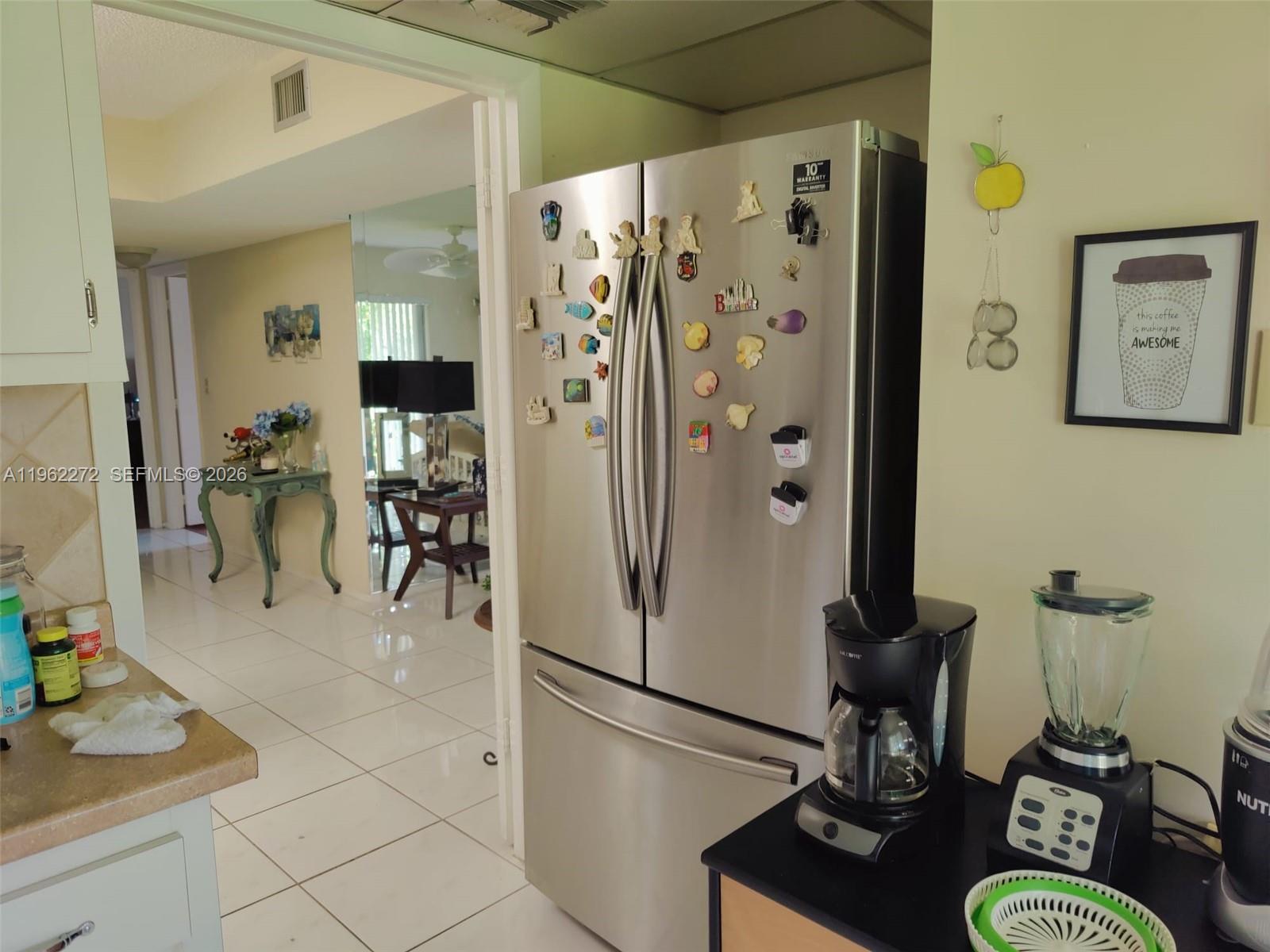 A kitchen features a stainless steel refrigerator, a coffee maker, and a blender on the counter — 4168 Inverrary Dr # 301, Lauderhill FL 33319, LAUDERHILL, FL